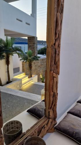 a mirror on a table with a view of a house at Mykonos Double Luxury Mini Suites-With External Hot spa Adults only in Ano Mera