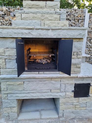 a stone fireplace in a stone wall at Złoty Dom Brenna in Brenna