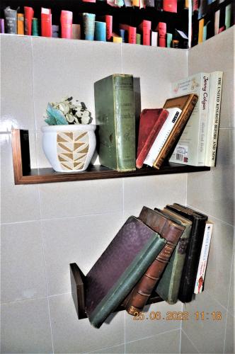 a shelf with books and a bowl on it at Social Guest House in Sofia