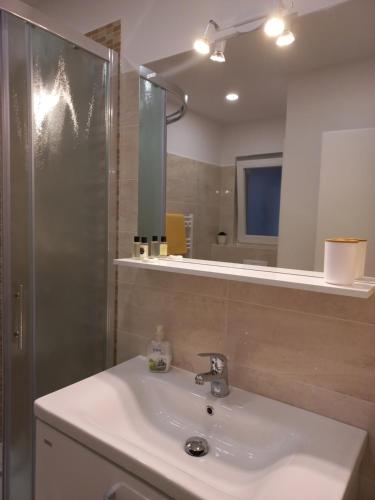 a bathroom with a sink and a mirror at Apartments Karmen in Portorož