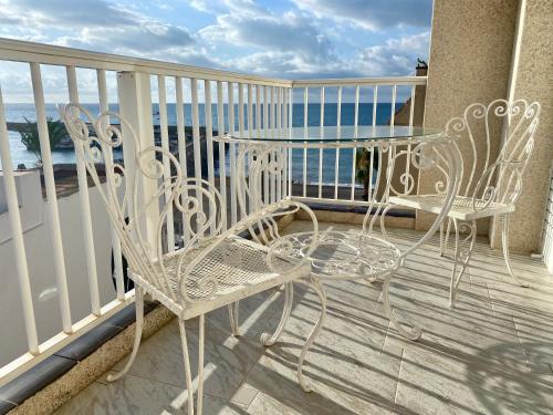a balcony with two chairs and a table on a balcony at Chez Marina in Les Cases d'Alcanar