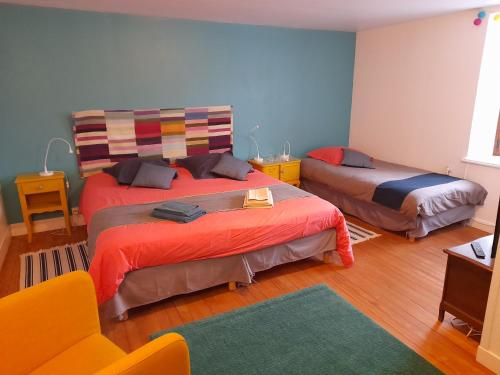 a living room with two beds and a couch at La maison du vannier in Raon-lès-Leau