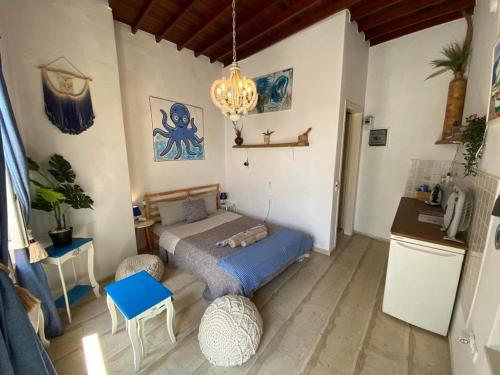 a bedroom with a bed and a chandelier at Octopus Blue in Mýkonos City