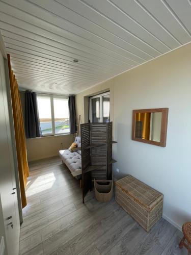 a living room with a bed and a couch and windows at A L'orée des vignes, superbe logement de 80 m2 in Wangen