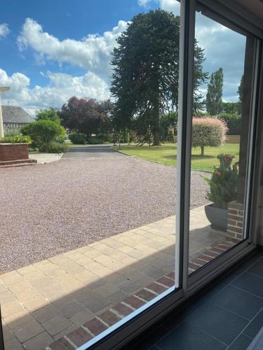 a view of a driveway seen through a window at Logement au calme avec piscine en saison 