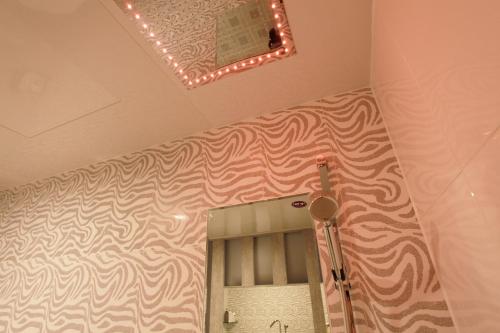 a bathroom with a mirror and a light on the ceiling at Boutique Hotel SB Yeouido in Seoul