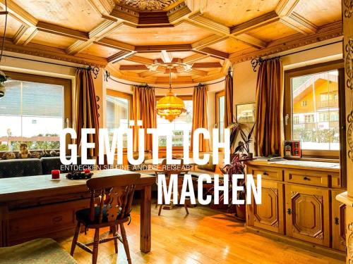 a kitchen with a wooden ceiling and a wooden table at Merryshof in Sankt Ulrich am Pillersee