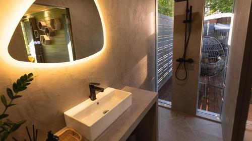 a bathroom with a sink and a mirror at KääraPesa in Vihtra