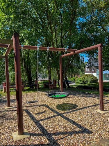 an empty swing set in a park at Resort LUFT Sněžník in Sněžnik
