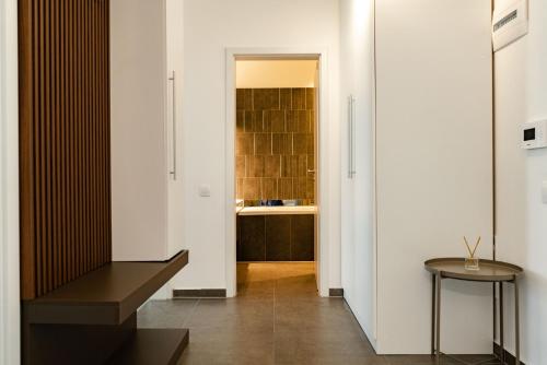 a hallway with a bench and a sink at Apart B&V 55 Qualis - Luxury Mountain Escape in Braşov