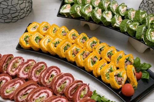 a buffet of food with different types of sushi at Aquamarine - Beach & SPA Hotel- All inclusive in Kranevo