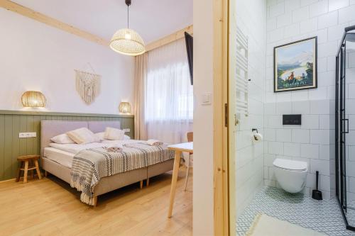 a bedroom with a bed and a bathroom with a shower at Panocek i Babka in Białka Tatrzanska
