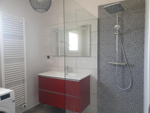 a bathroom with a shower with a red cabinet at Gite des Clapas Flora, villa avec piscine privée in Balazuc