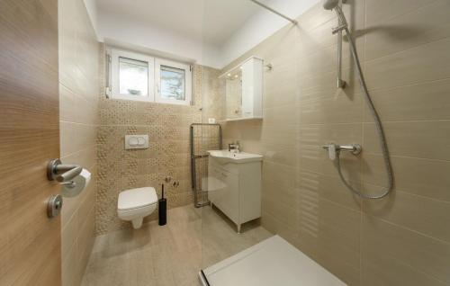 a bathroom with a shower and a toilet and a sink at Apartmani Kraljevica in Kraljevica