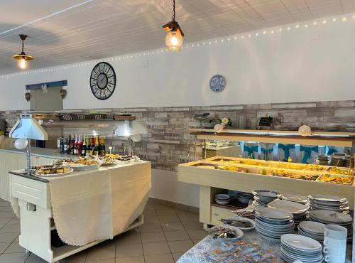 a kitchen with a counter with plates and dishes at Goldschmiedt Vendégház in Pálköve