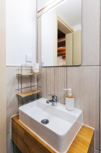 a bathroom with a white sink and a mirror at guesthouse LIPA in Korenica