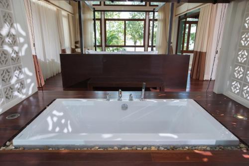 a large bath tub in a room with at Amatapura Beachfront Villa 14, SHA Certified in Ao Nam Mao