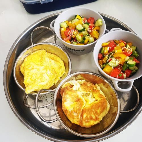 four bowls of food on a tray with a pie and a salad at חצבים על הואדי in Arad