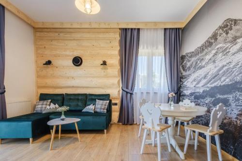 a living room with a couch and a table at Panocek i Babka in Białka Tatrzanska