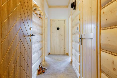a hallway with wood paneling and a door at Panocek i Babka in Białka Tatrzanska