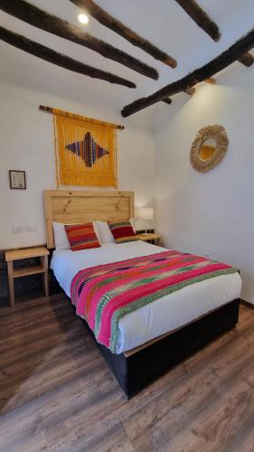 a bedroom with a large bed in a room at CASA CRISTOBAL Siete Cuartones in Cusco