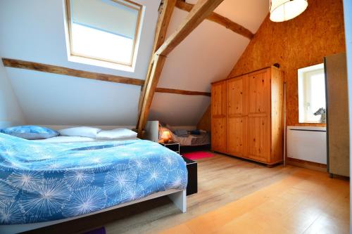 a bedroom with a bed and a window at Gîte de la vallée in Saint-Hilaire-la-Gravelle
