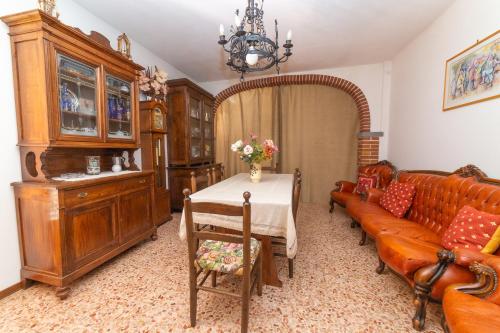 a living room with a table and a couch at La Casina del Teso in Maresca
