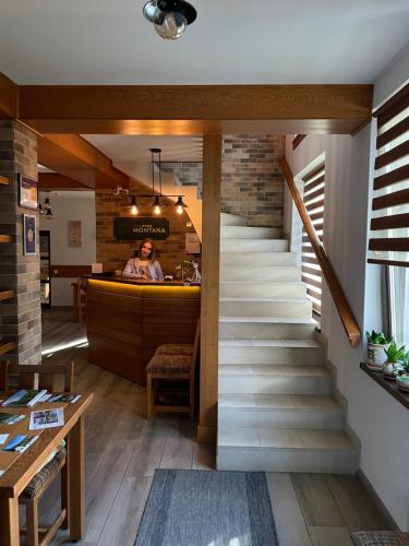 a staircase leading up to a bar in a restaurant at Villa Montana Borsec - Vedere Munte in Borsec