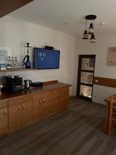 a living room with a flat screen tv on the wall at Villa Montana Borsec - Vedere Munte in Borsec