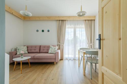a living room with a couch and a table at Panocek i Babka in Białka Tatrzanska