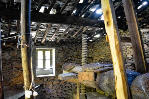 a room with a window in a stone building at Casa do Amieiro, Cantinho do Céu in Casal do Rei