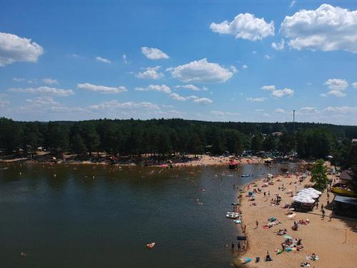 a beach with a bunch of people on the water at Domek -Radawa-Królewska 77b,domek Dorota in Radawa