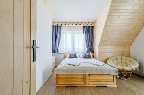 a bedroom with a bed and a window at Panocek i Babka in Białka Tatrzanska
