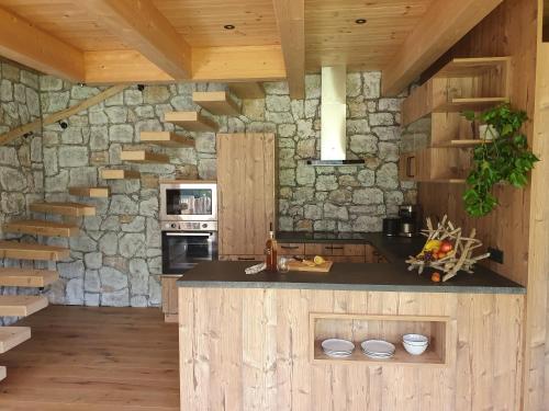 a kitchen with a stone wall and a staircase at Bichlhof in Kaisers