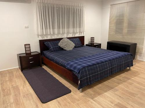 a bedroom with a bed and two night stands at Tamborine Accommodation 84 Eagle Heights Road 6 Bedroom 3 Baths Parking Complete Holiday Home in Mount Tamborine