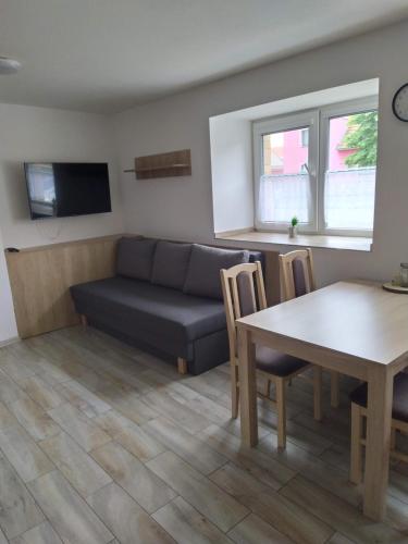a living room with a couch and a table at Ubytování na statku Račice in Račice
