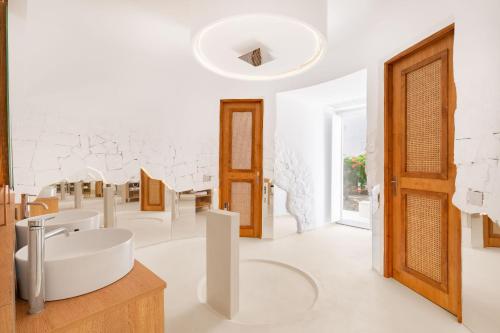 a bathroom with a sink and a mirror at Faos Exclusive Suites in Ornos