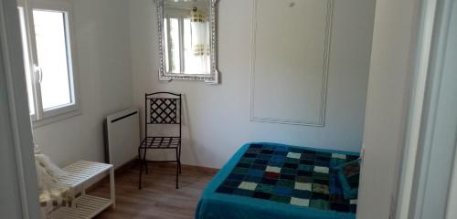 a bedroom with a bed and a mirror and a chair at KAPH in Millau