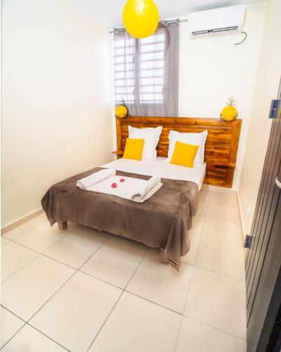 a bedroom with a large bed with avertisementatronatronstrationstrationstrationstrationstration at Evasion en plein cœur de la ville T3 Jacuzzis Sauna et piscine au centre de Port-Louis in Port-Louis