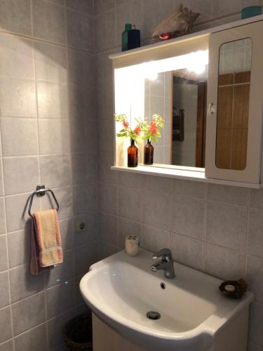 a bathroom with a sink and a mirror at Authentic Vila Nona by NYC Interior Architect in Susak
