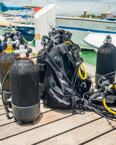 a group of equipment on a dock next to a boat at Evasion en plein cœur de la ville Studio Jacuzzis Sauna et piscine au centre de Port-Louis in Port-Louis