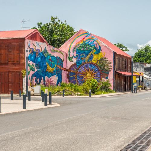 a mural on the side of a building on a street at Evasion en plein cœur de la ville T2 Jacuzzis Sauna et piscine au centre de Port-Louis in Port-Louis