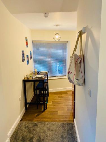 a small dining room with a table and a window at Folly View - Settle in Settle