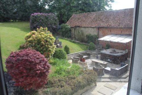 a view of a garden with a grill and a building at Rainworth Lodge in Nottingham