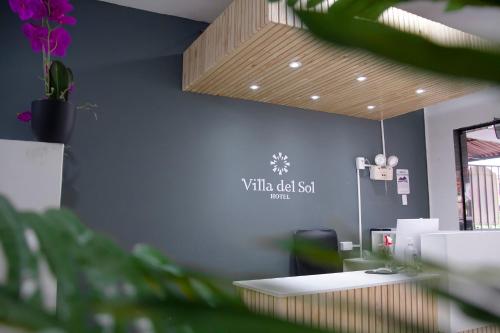 an office with a white desk and a blue wall at Hotel Villa del Sol in Piura
