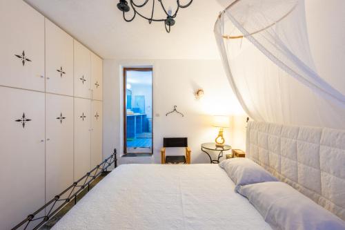 a bedroom with a bed and a window at Panorama Maisonette in Livadia