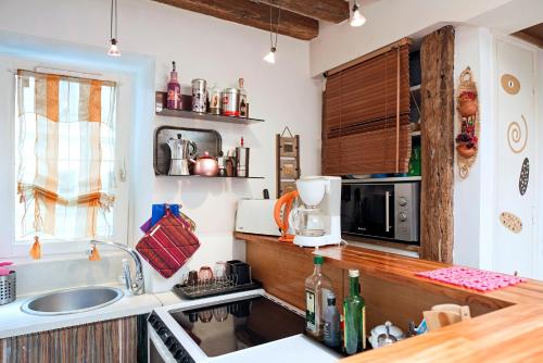 une cuisine avec un évier et un micro-ondes dans l'établissement Camallo Paris, à Paris