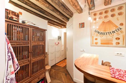 a room with a table and a wooden shelf at Camallo Paris in Paris