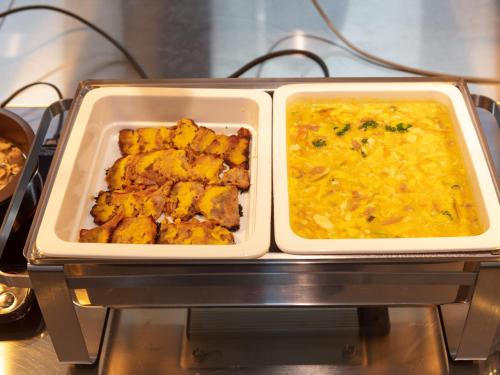 two trays of food sitting on top of a stove at Ariston Hotel Kyoto Jujo in Kyoto