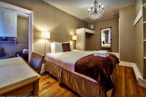 Säng eller sängar i ett rum på Les Maisons Montcalm